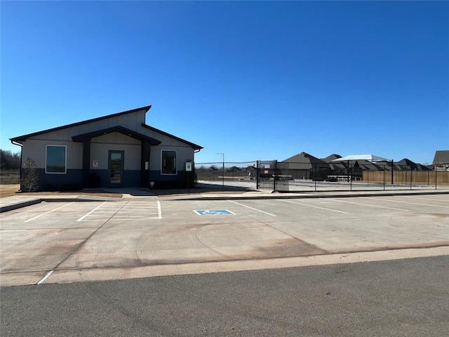 uncovered parking lot featuring fence