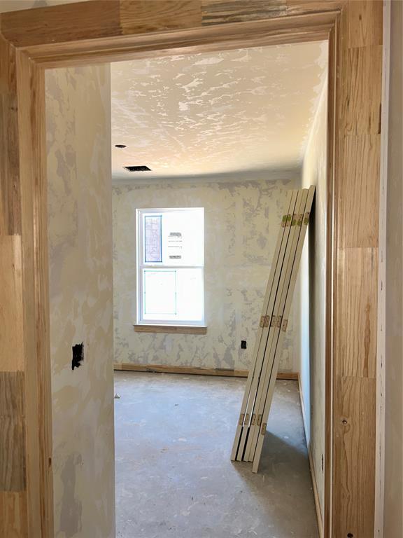 unfurnished room featuring unfinished concrete flooring