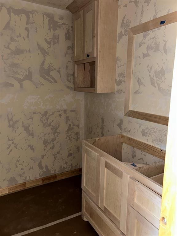 bathroom with baseboards and wallpapered walls