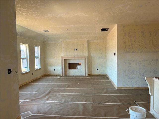 unfurnished living room with vaulted ceiling and a fireplace