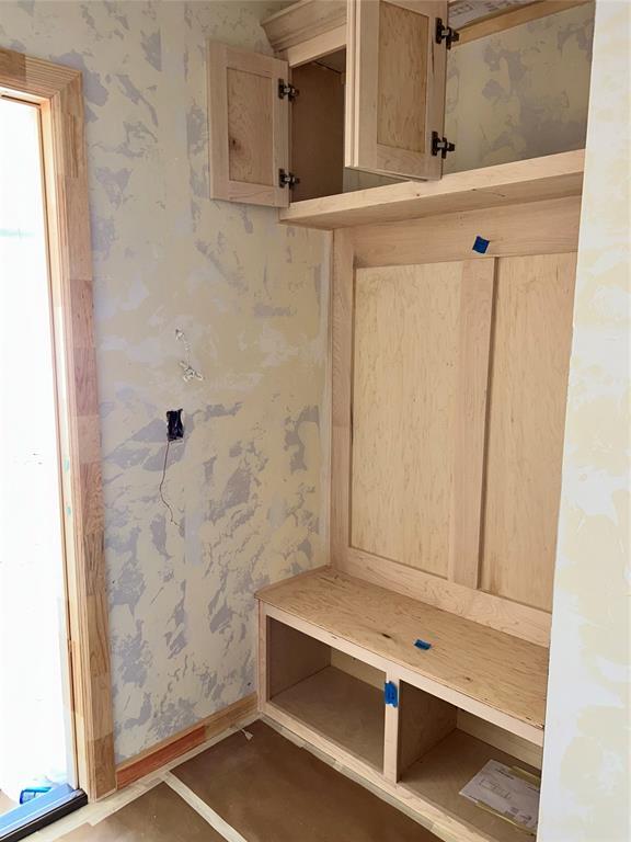 mudroom featuring baseboards and wallpapered walls