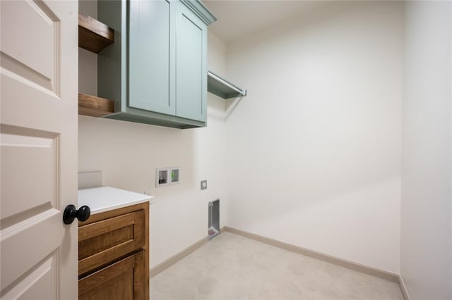 4813 Mistywood Ln, Mustang, OK 73064 - laundry area with hookup for a washing machine, cabinet space, electric dryer hookup, baseboards, and light flooring