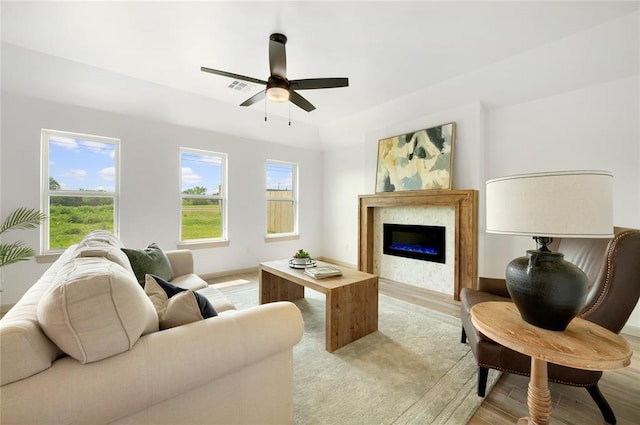 4813 Mistywood Ln, Mustang, OK 73064 - living room featuring a glass covered fireplace, a ceiling fan, light wood-style floors, and baseboards