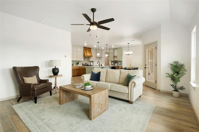 4813 Mistywood Ln, Mustang, OK 73064 - living room featuring a ceiling fan, light wood-style floors, a chandelier, baseboards, and recessed lighting
