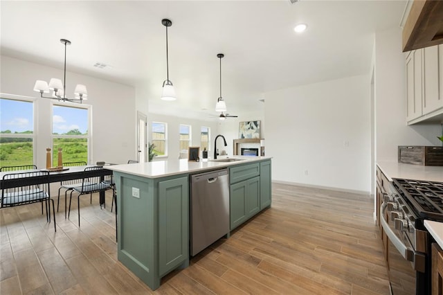 4813 Mistywood Ln, Mustang, OK 73064 - kitchen with green cabinetry, appliances with stainless steel finishes, a sink, light countertops, and recessed lighting