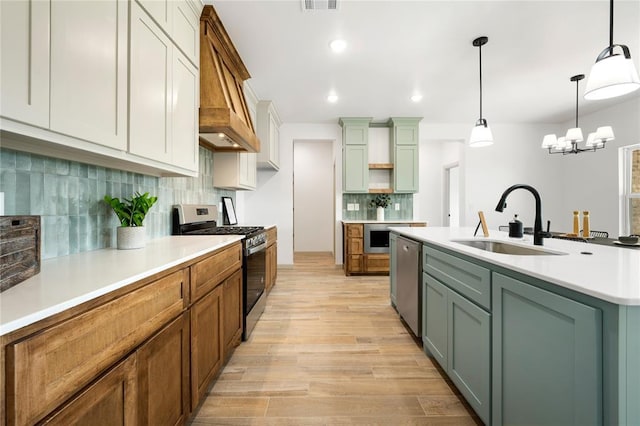 4813 Mistywood Ln, Mustang, OK 73064 - kitchen featuring appliances with stainless steel finishes, a sink, light wood-type flooring, custom exhaust hood, and tasteful backsplash