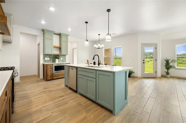 4813 Mistywood Ln, Mustang, OK 73064 - kitchen featuring green cabinetry, a sink, appliances with stainless steel finishes, light wood-style flooring, and light countertops