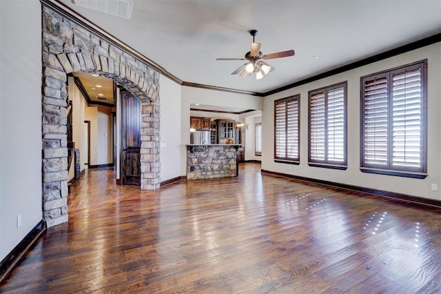 unfurnished living room featuring dark hardwood / wood-style floors, ceiling fan, and ornamental molding