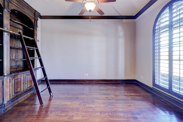 unfurnished room with ceiling fan, a wealth of natural light, ornamental molding, and dark wood-type flooring