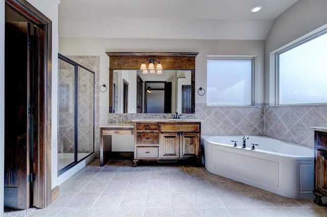 bathroom featuring vanity, lofted ceiling, and plus walk in shower