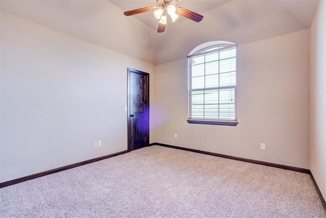 spare room featuring ceiling fan, carpet, and vaulted ceiling