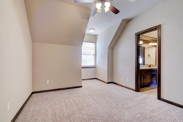 bonus room featuring ceiling fan, light colored carpet, and lofted ceiling