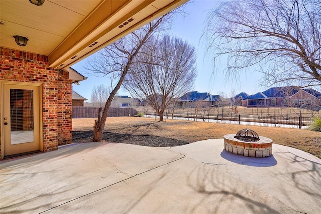 view of patio / terrace featuring an outdoor fire pit and a mountain view