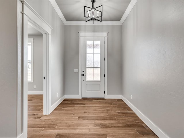 doorway featuring crown molding and an inviting chandelier