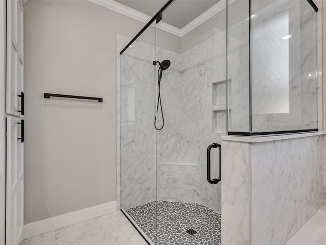 bathroom with a shower with door and crown molding