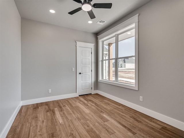 spare room featuring light hardwood / wood-style flooring and ceiling fan