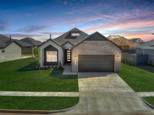 view of front facade with a yard and a garage