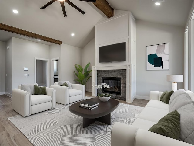 living room featuring lofted ceiling with beams, ceiling fan, and light wood-type flooring