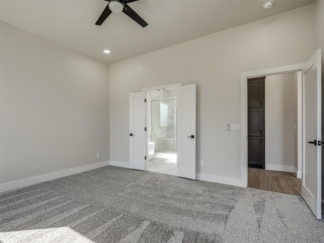 unfurnished bedroom with carpet, connected bathroom, and ceiling fan