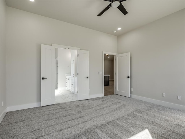 unfurnished bedroom with ceiling fan and light colored carpet