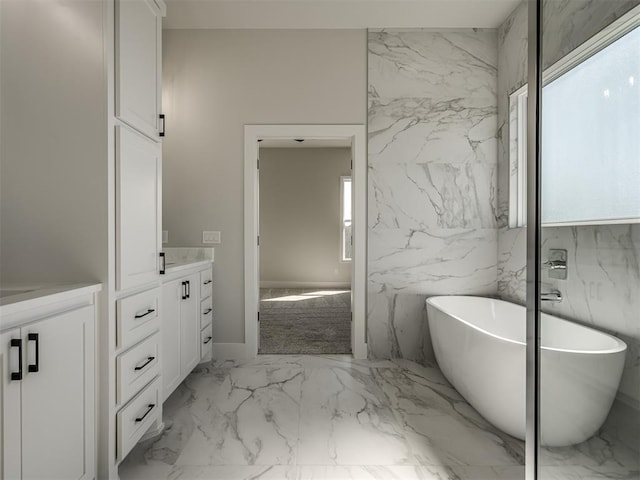 bathroom with vanity and a bath