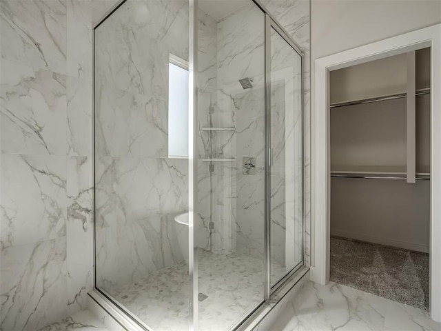 bathroom featuring a shower with shower door