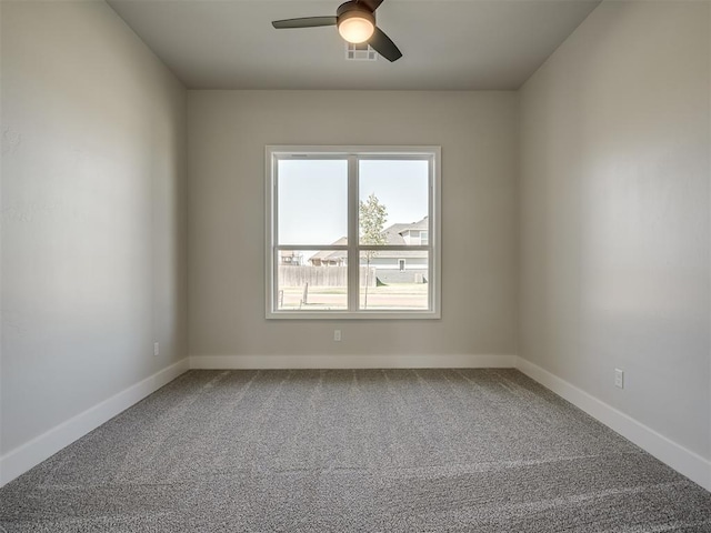 carpeted spare room featuring ceiling fan