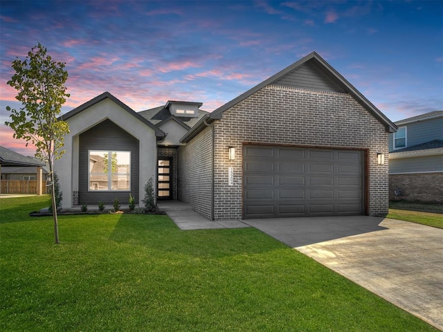 view of front of house with a garage and a lawn