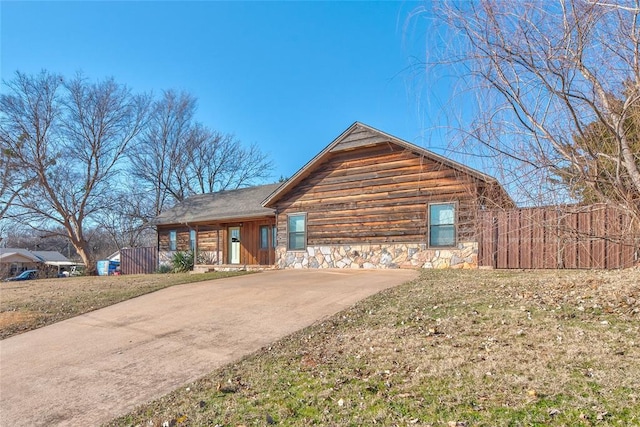 log cabin with a front lawn