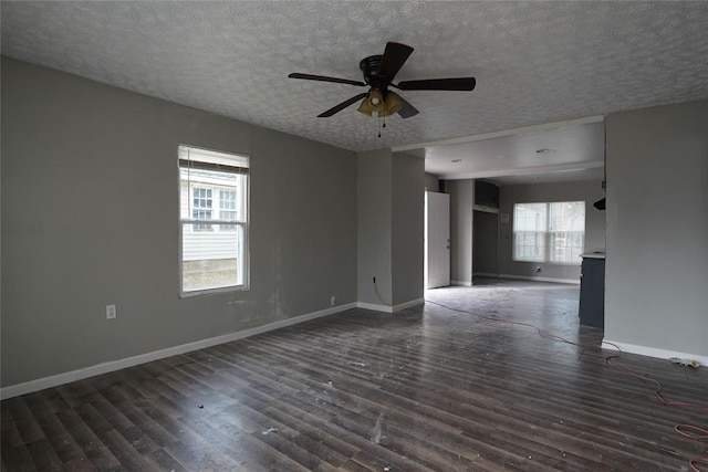 unfurnished room with a textured ceiling, ceiling fan, and dark hardwood / wood-style flooring