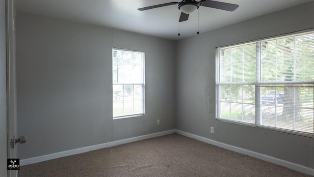 313 W Texas Ave, Anadarko, OK 73005 - carpeted empty room featuring plenty of natural light and ceiling fan