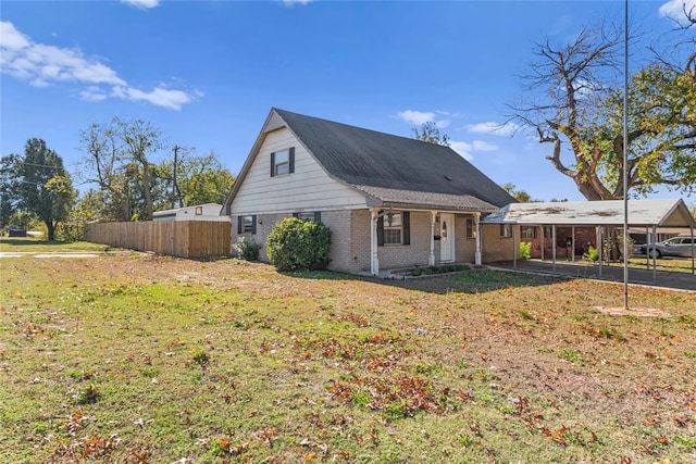 exterior space featuring a lawn and a carport