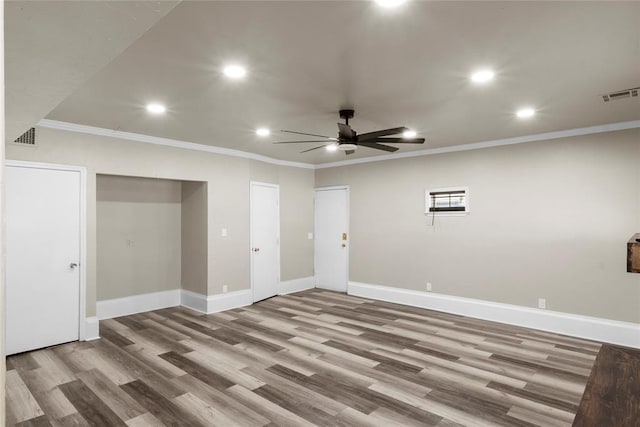 interior space featuring ceiling fan, hardwood / wood-style floors, and crown molding