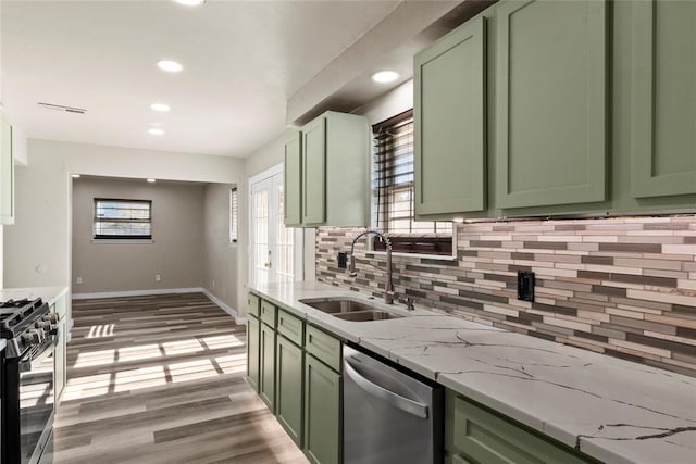 kitchen with green cabinetry, sink, dishwasher, and range with gas cooktop