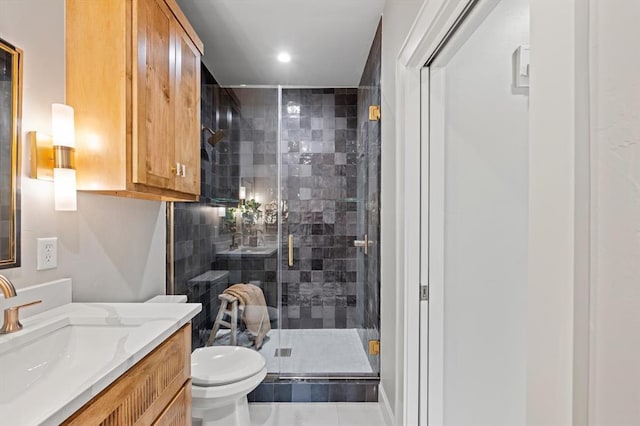 bathroom with vanity, toilet, tile patterned floors, and an enclosed shower