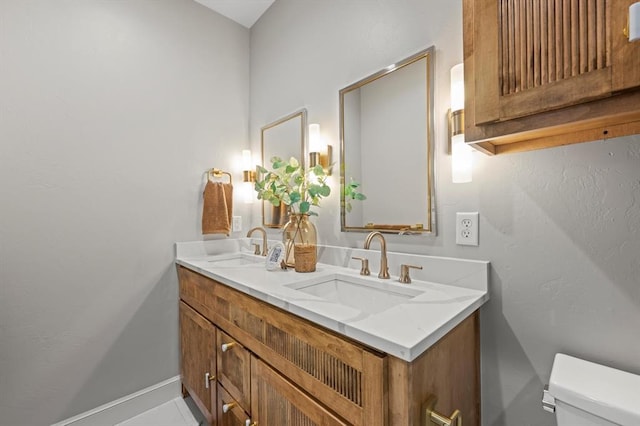 bathroom with vanity, toilet, and tile patterned flooring