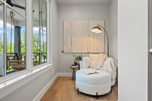 sitting room with wood-type flooring