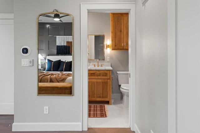 bathroom featuring toilet, tile patterned flooring, and vanity