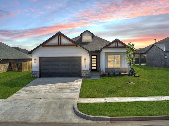 view of front of house featuring a yard and a garage