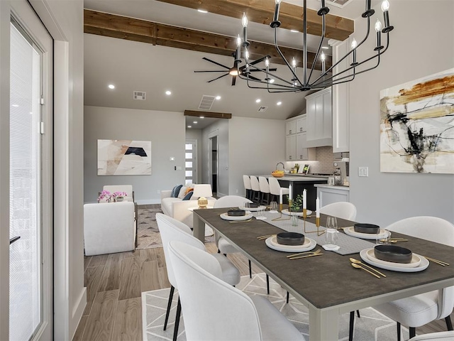 dining space with high vaulted ceiling, light hardwood / wood-style floors, and beamed ceiling