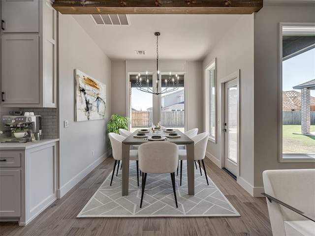 dining room with an inviting chandelier and light hardwood / wood-style floors