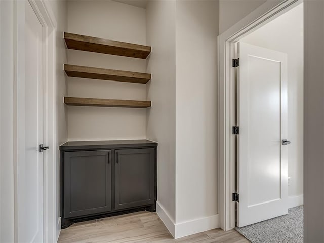 corridor with light hardwood / wood-style flooring