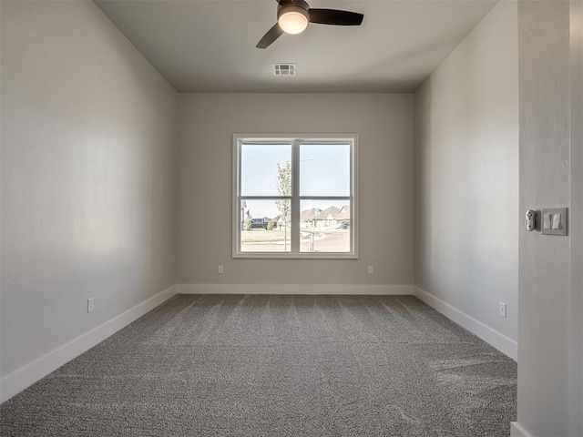 carpeted spare room featuring ceiling fan