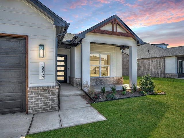 exterior entry at dusk with a yard