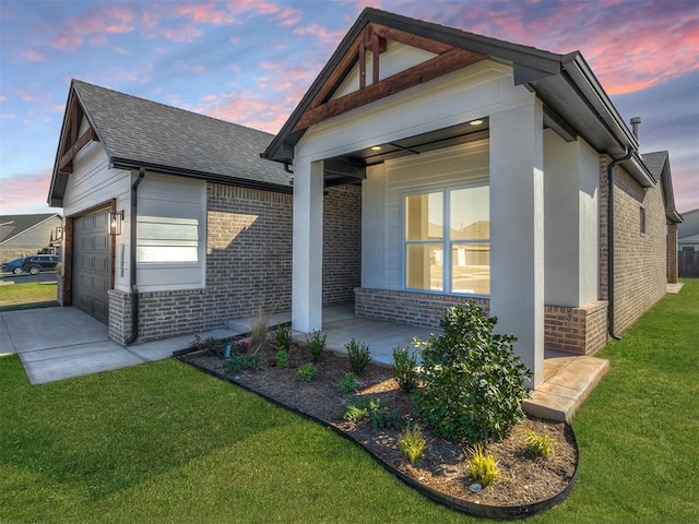 craftsman-style house featuring a garage and a yard