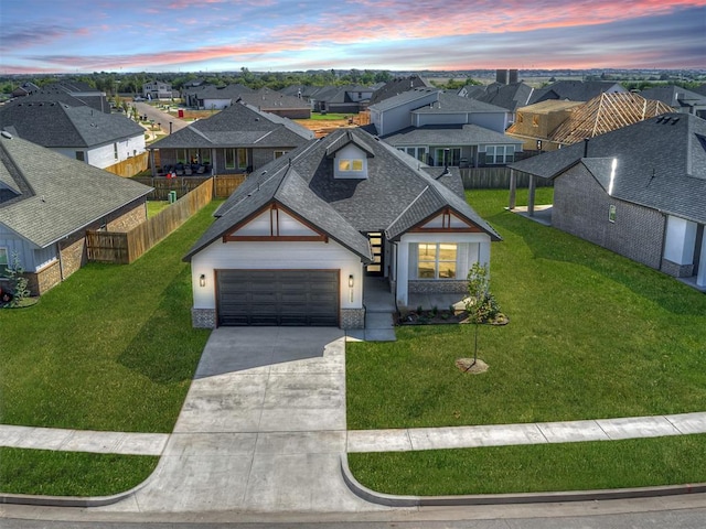 view of front of property featuring a garage and a lawn