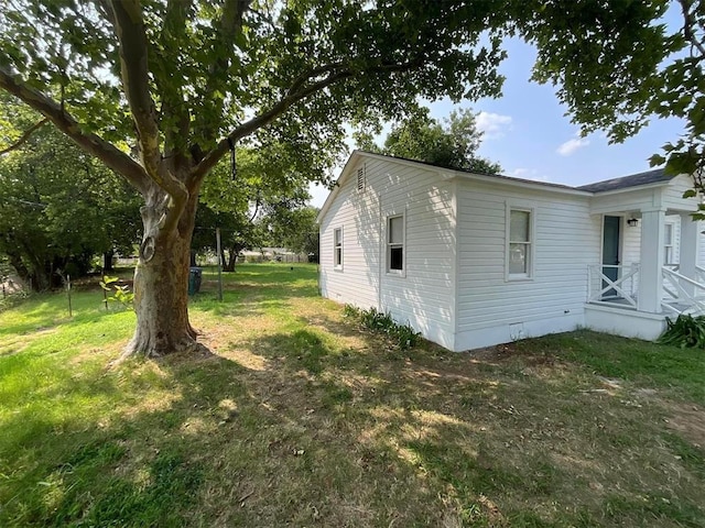 view of side of home featuring a lawn