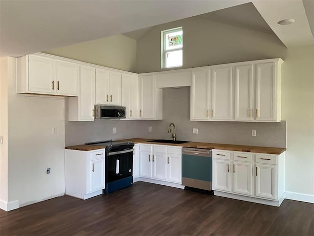 kitchen with high vaulted ceiling, sink, white cabinets, stainless steel appliances, and dark wood-type flooring