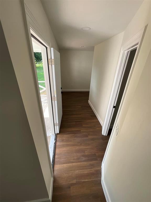 hallway with dark hardwood / wood-style floors