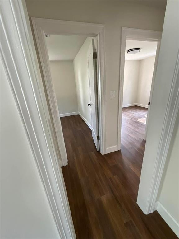 corridor featuring dark hardwood / wood-style flooring